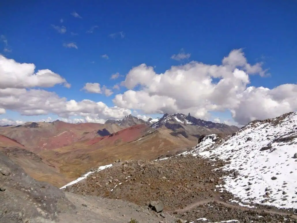 a view of Apu Ausangate mountain range with snow and a blue sky.
