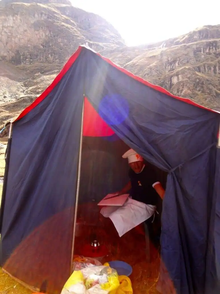A man trekking inside a tent during the Apu Ausangate expedition.