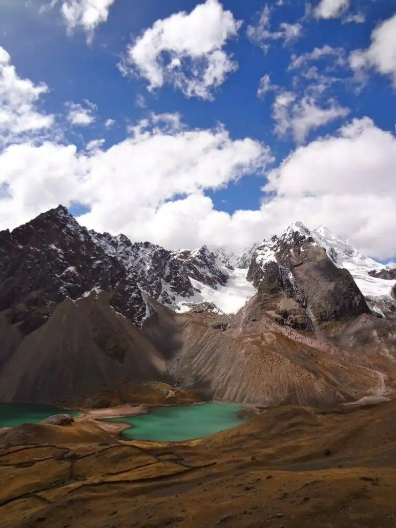 Apu Ausangate trekking offers breathtaking views of a mountainous lake.