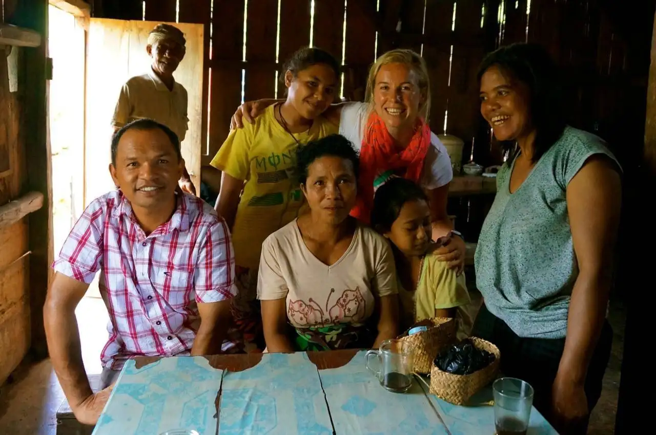 Sharing a homestay dinner with local friends in Flores, Indonesia, an example of slow travel cultural exchange