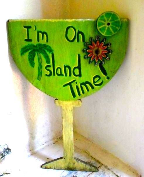 a wooden sign that embodies slow travel with its message of being on island time.