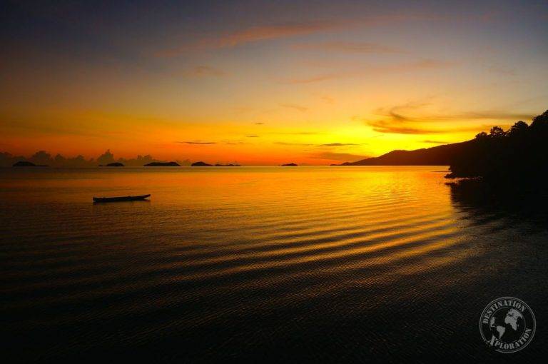 A boat gracefully cruises through the water during a mesmerizing sunset in Riung, Flores.