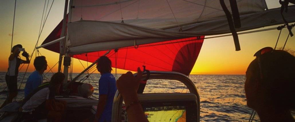 A crew of sailors embarks on an Atlantic journey at sunset.