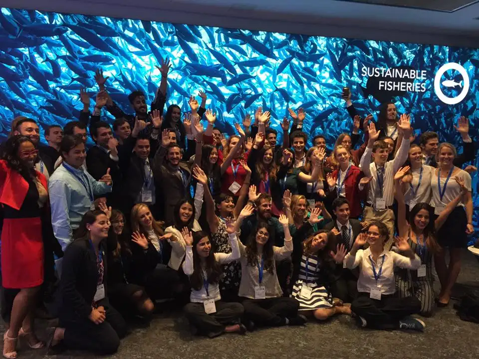 a group of people posing for a photo at a conference.