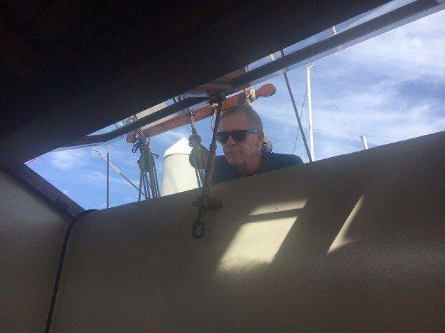 A Nomad gazing out the window of a sailboat.