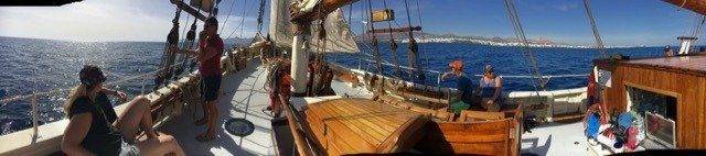 A view from the deck of a sailing ship exploring the vastness of the ocean.
