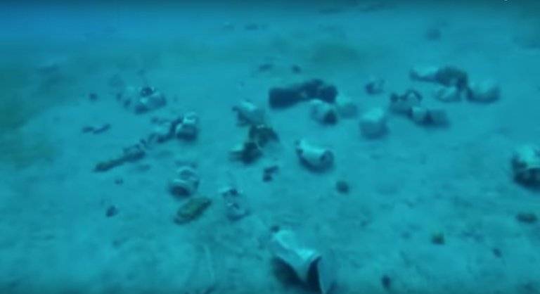 discarded plastic bottles left on sandy beach.