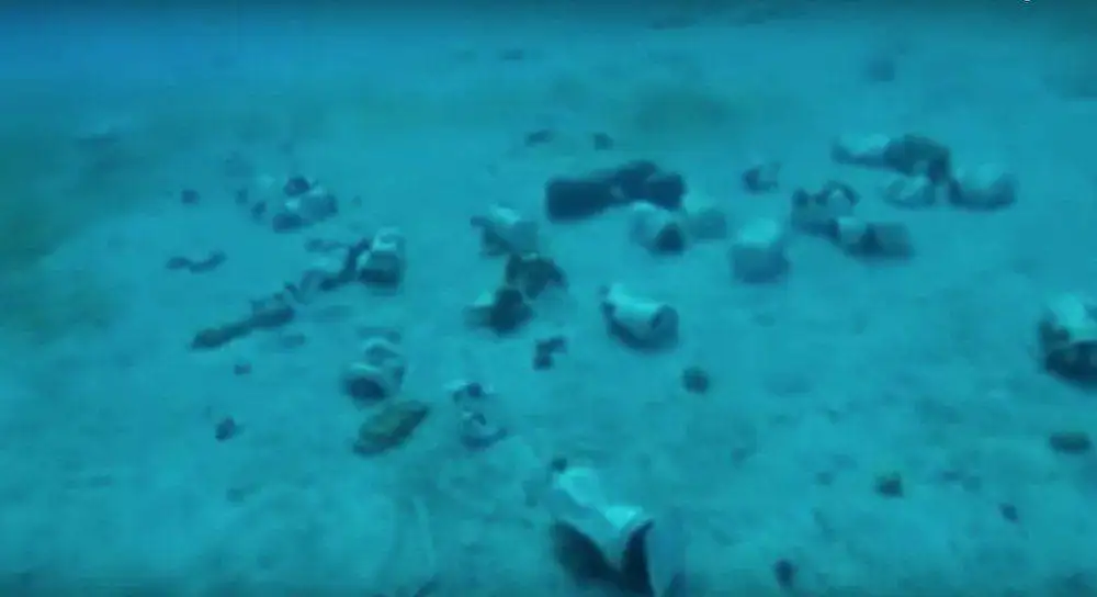 discarded plastic bottles left on sandy beach.
