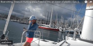 a woman is standing on a boat with a cell phone.