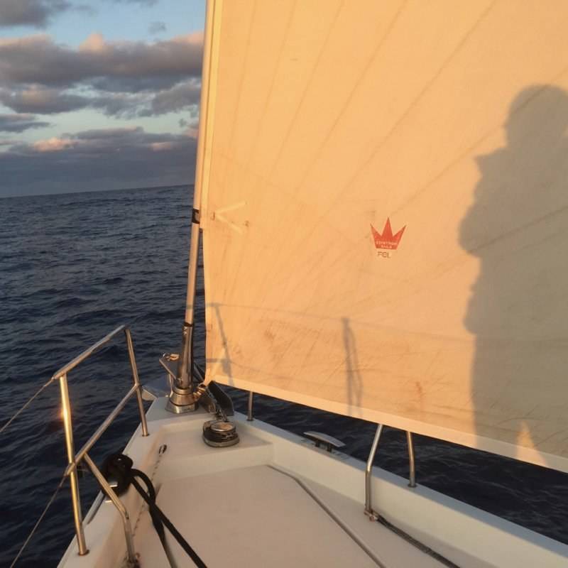 the shadow of a person on a sailboat.