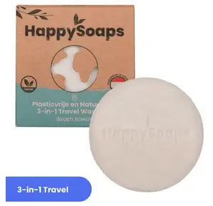 Packaging of a HappySoaps 3-in-1 Travel Wash in "Beach Breeze" scent. The round soap bar is shown outside its brown and green box.