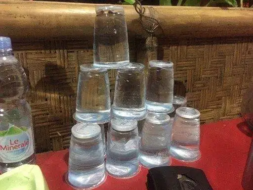 A stack of disposable plastic cups on a table.
