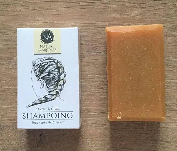 A bar of chemical-free shampoo with a box next to it.