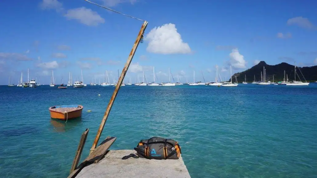 A boat docked in the water, ready for sailing.