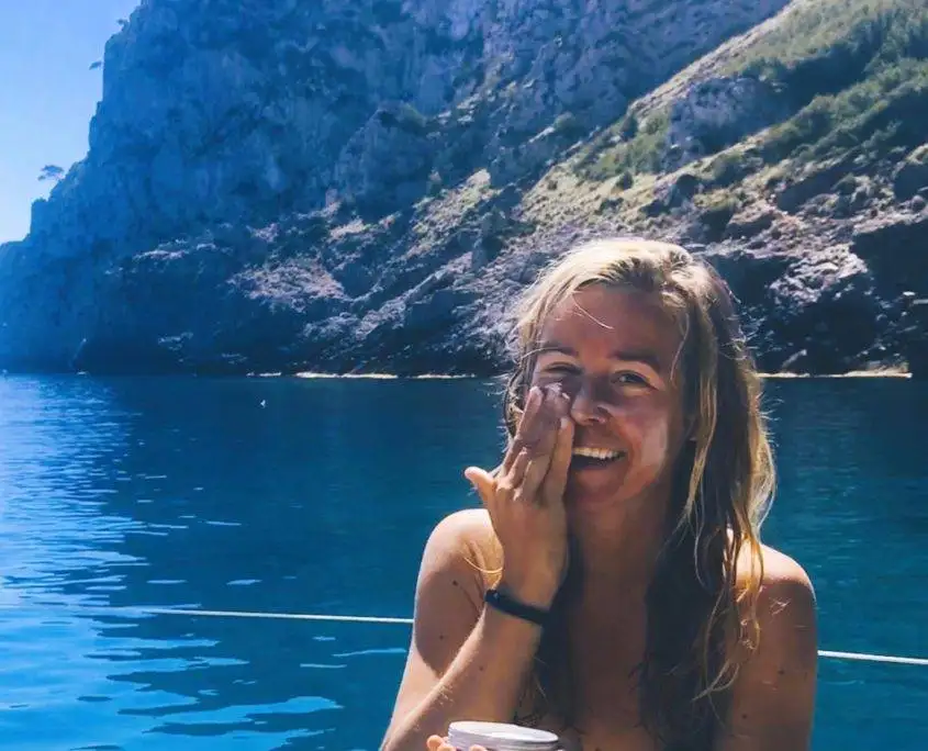 Suzanne wearing homemade non-nano zinc oxide sunscreen on a sunny coastal day
