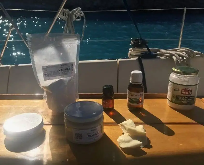 Homemade reef-safe sunscreen ingredients with non-nano zinc oxide mixed in a small metal tin