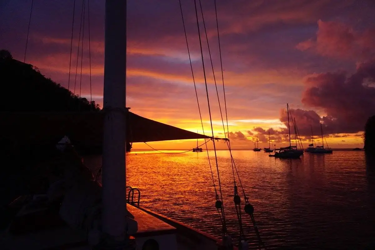 Sunset from a sailboat at sea, boatsitting opportunity through Ocean Nomads community.