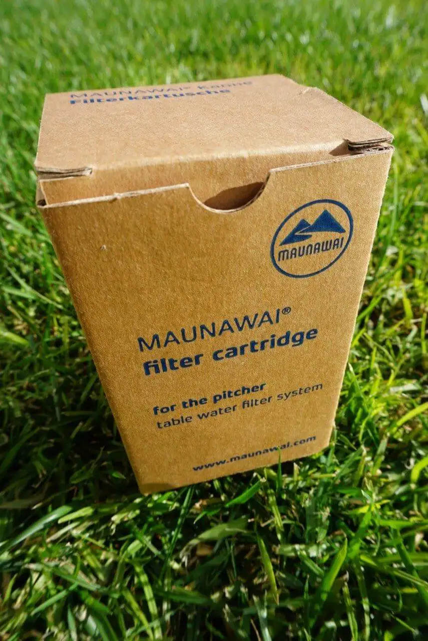 a box of mauwai water filter strips sitting on the grass.