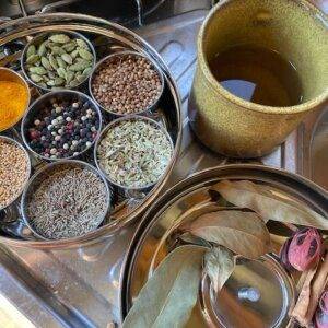 a Masala Dabba of spices on a stove top.