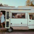 Two women standing in the door of a Chalk Sticker camper van.