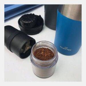 a coffee mug with a Rubytec Portable Spice/Coffee grinder next to it.