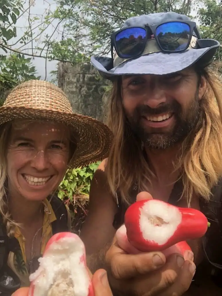 Suzanne and Jonatan holding wild water apples on the Waitukubuli Trail.