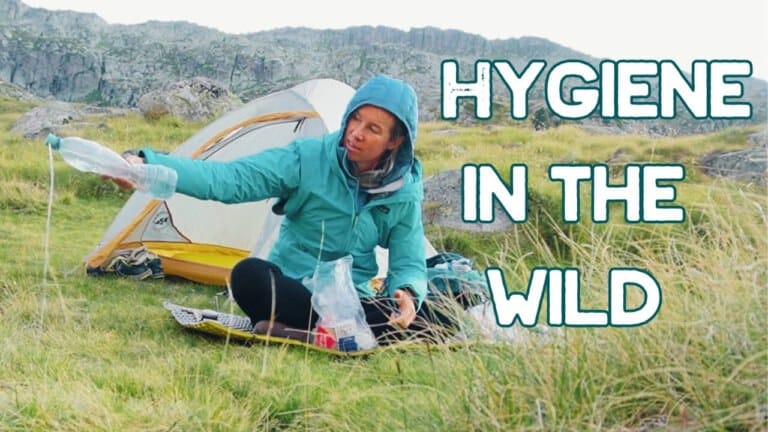 A person in outdoor gear sits by a tent in a grassy area, pouring water from a bottle. Large text reads, "Hygiene in the Wild.