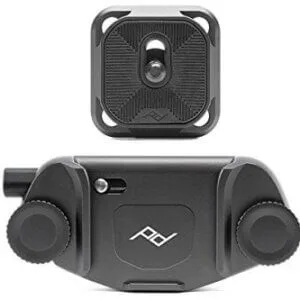The Peak Design Backpack Camera Clip is a black clip and mounting plate with screws and knobs for securely attaching your camera to a strap or belt.