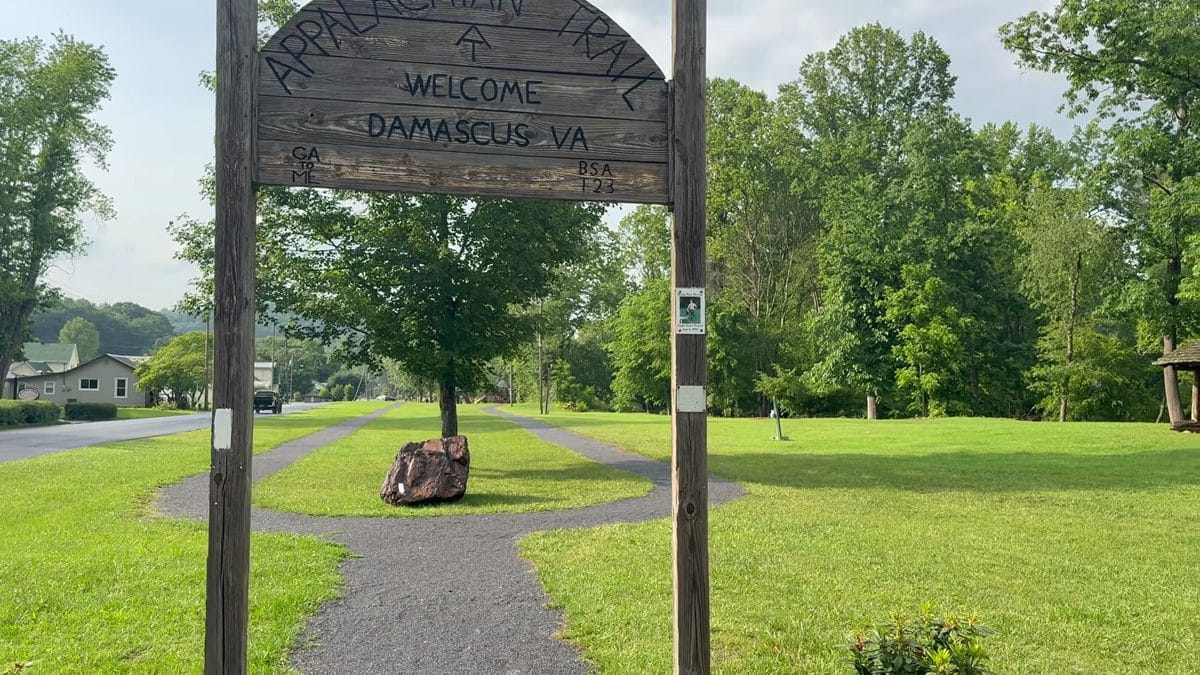 Wooden trail marker sign reading Tennessee and Virginia state line on the Appalachian Trail