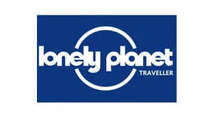 Lonely Planet Traveller logo with white text and circular design on a blue background.