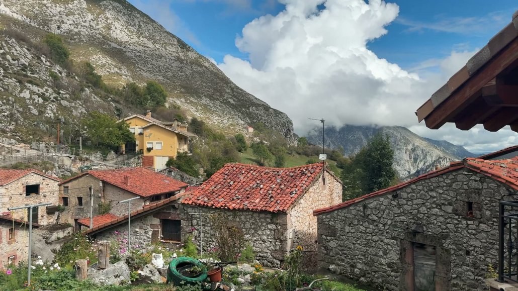 Stone houses with red roofs in a mountain village in the Picos de Europa