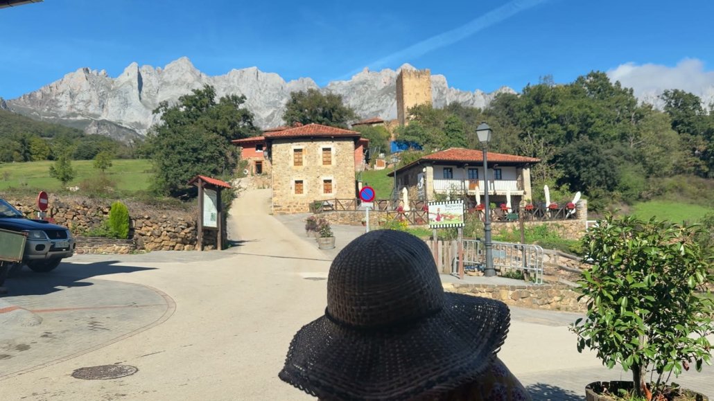 A stone village at the foot of the Picos de Europa, with the limestone peaks behind it