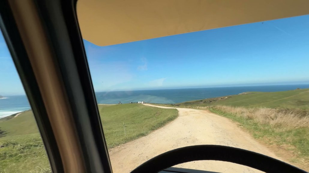Driving the van along a coastal track to the ocean in northern Spain